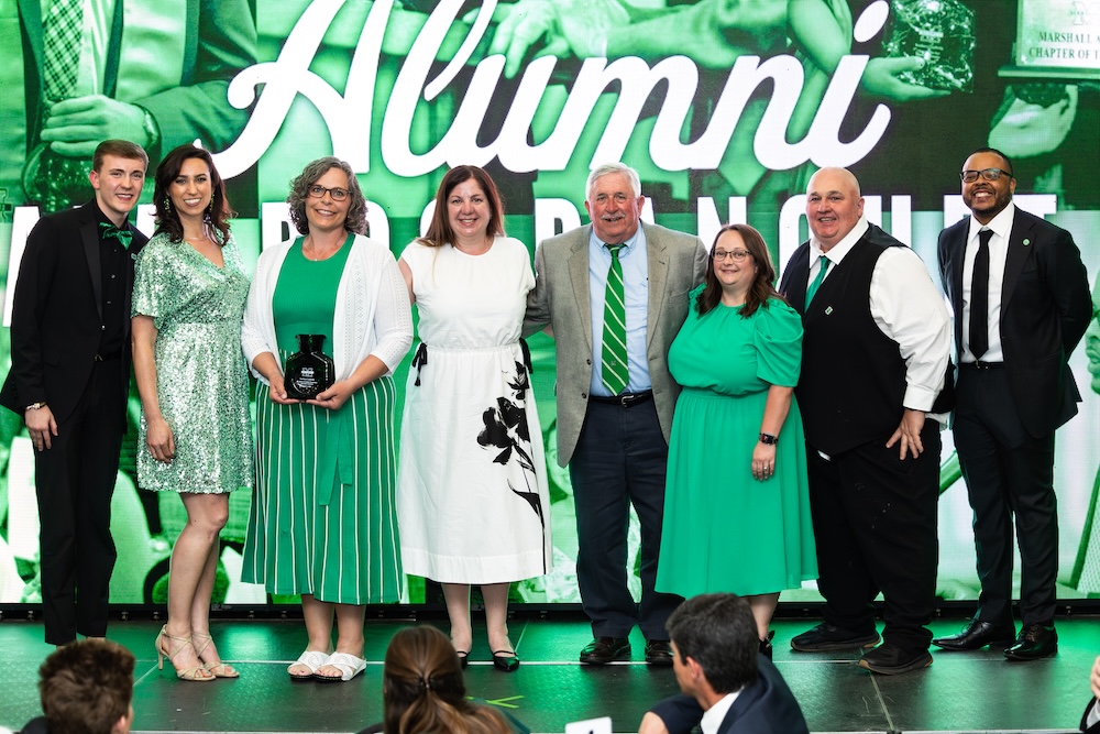 Members of a Marshall University alumni chapter pose with an Alumni Awards recognition during the university's Annual Alumni Awards celebration.